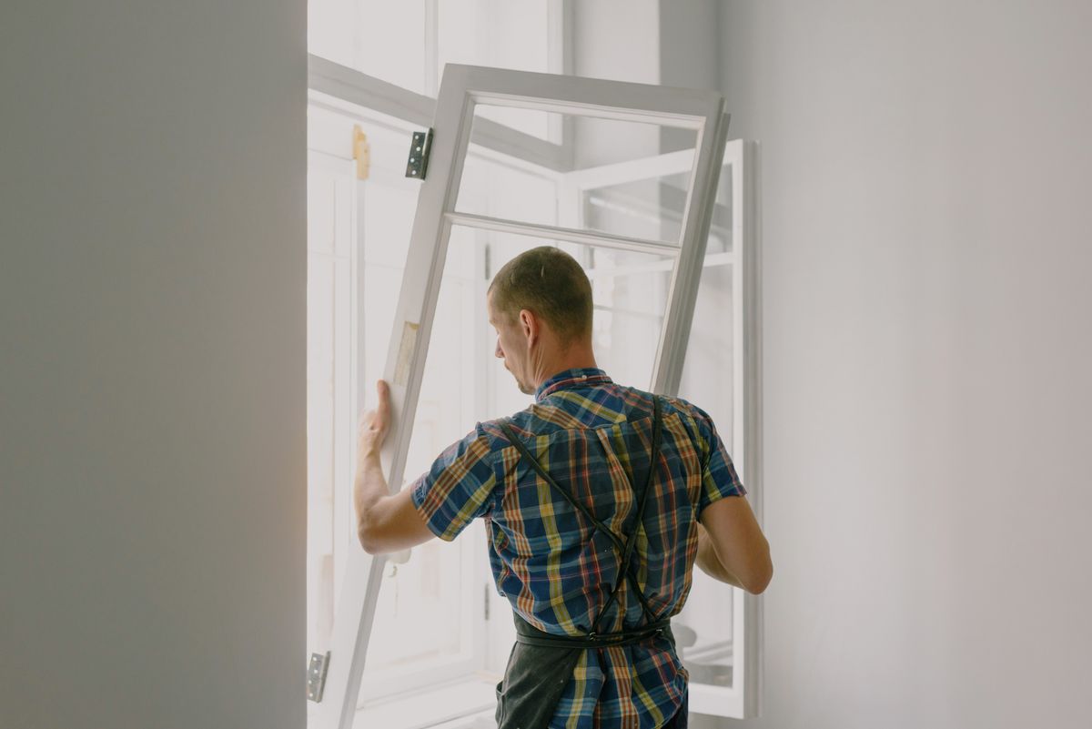 Professional installer fitting a new house window